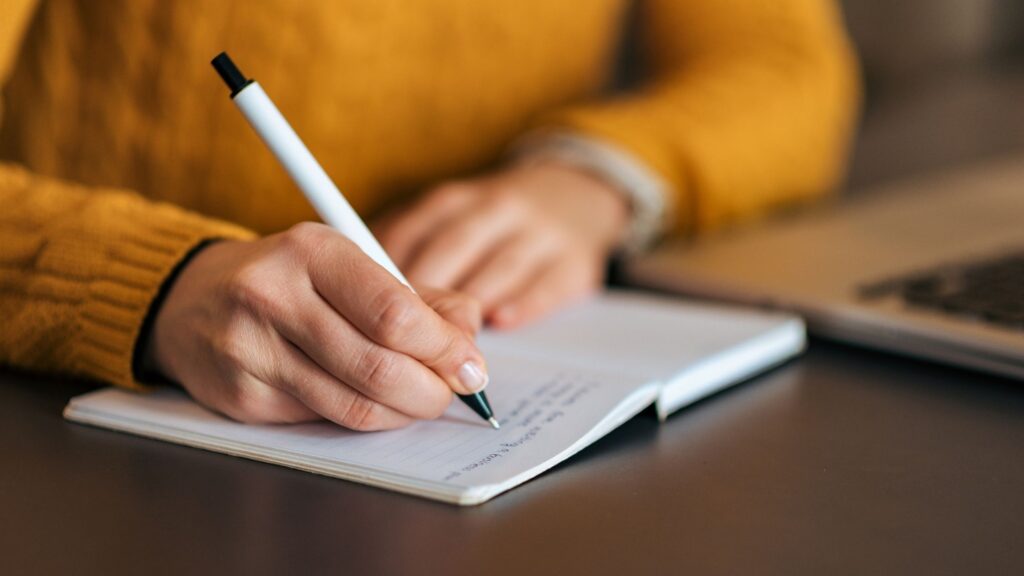 Expert Writing in a yellow sweater